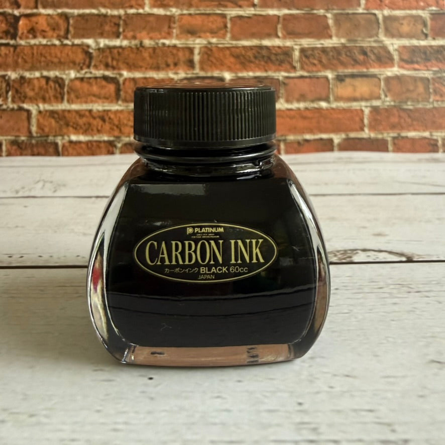 Platinum Carbon Ink Black pigment fountain pen ink in a 60 mL glass bottle with a black and gold label