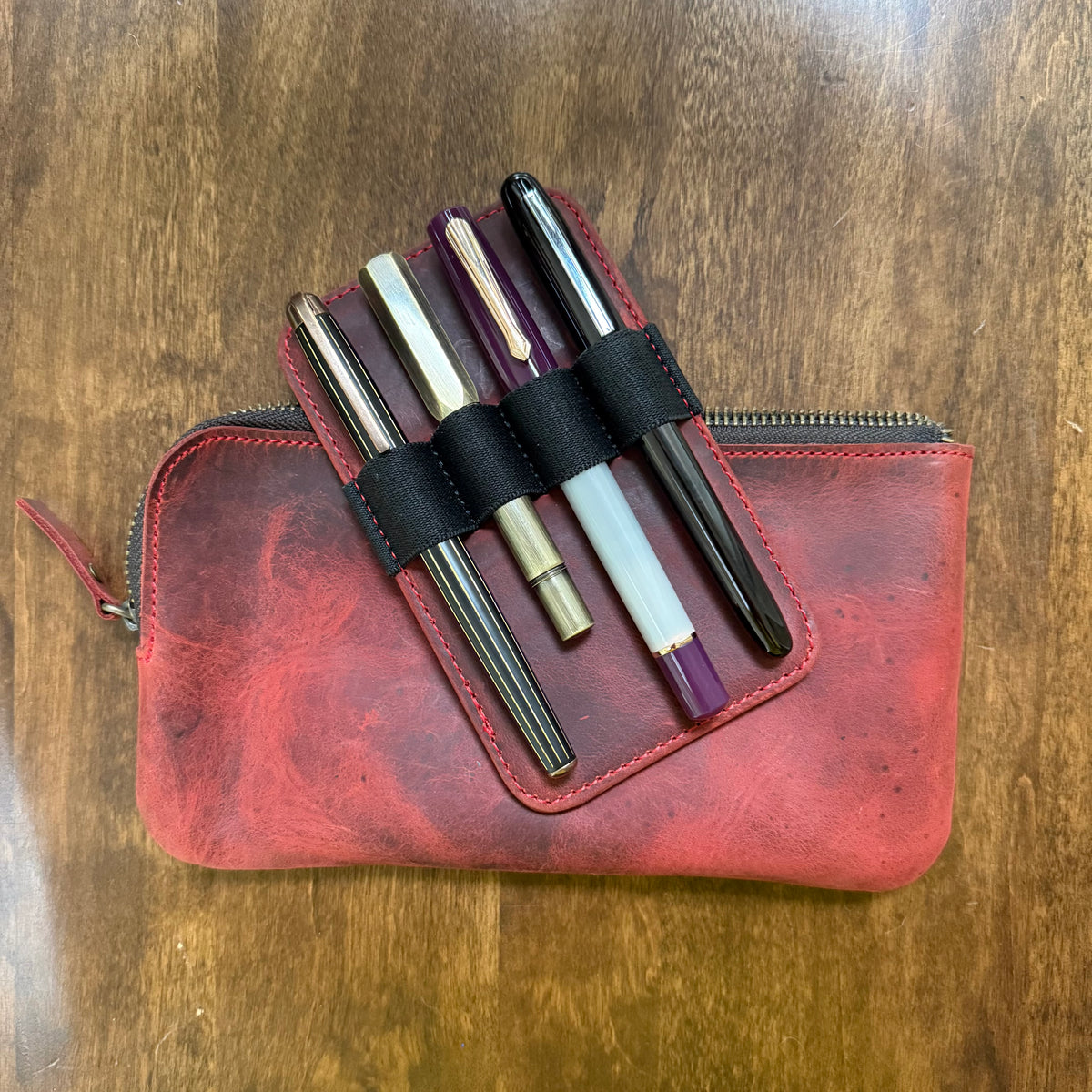 Removable red leather 4-pen insert with black elastic pen loops, shown on its own