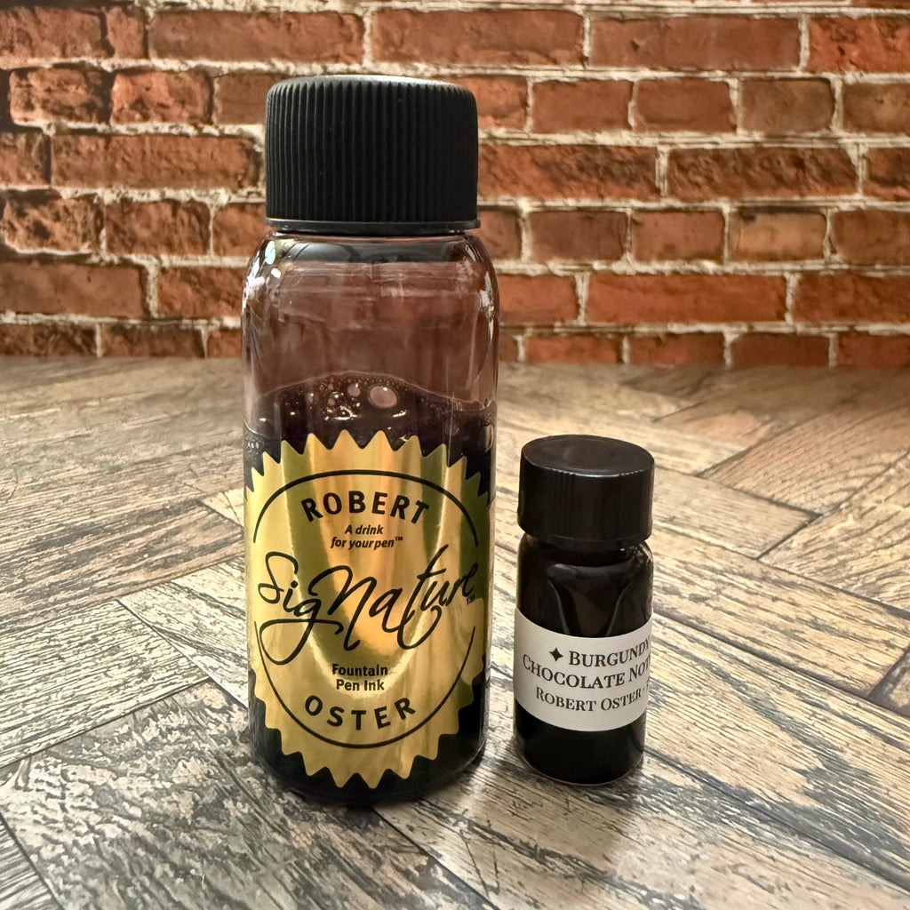 5 mL specimen bottle of Robert Oster Burgundy Chocolate Notes beside the 50 mL Robert Oster Signature source bottle (not included)