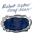 A blue ink swatch on textured paper, labeled with the handwritten text 'Robert Oster Grey Seas' at the top.