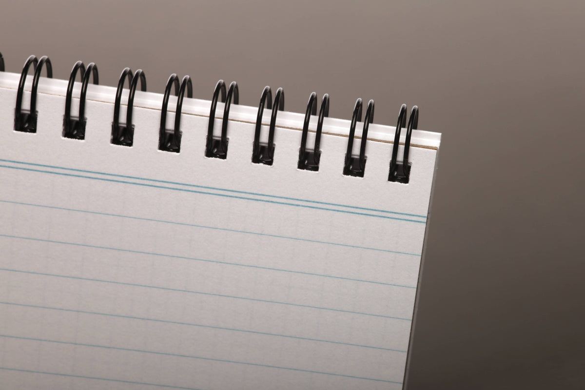 Ruled pages under the spiral binding of a Field Notes Heavy Duty notebook