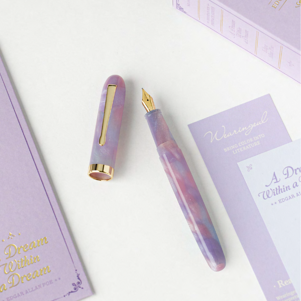 Wearingeul A Dream Within a Dream Preface Series fountain pen in pink-violet and blue cellulose acetate with gold-tone trim and literary packaging.