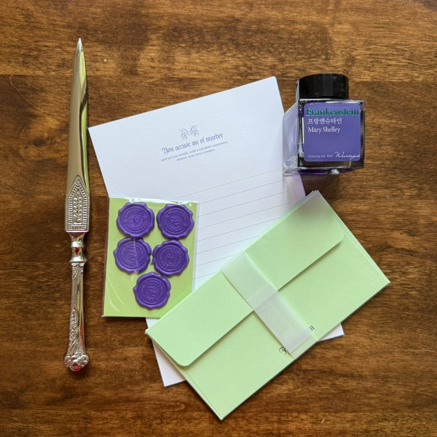 Contents of the Wearingeul Frankenstein Letter Writing Set with pale green letter sheets, envelopes and seal stickers