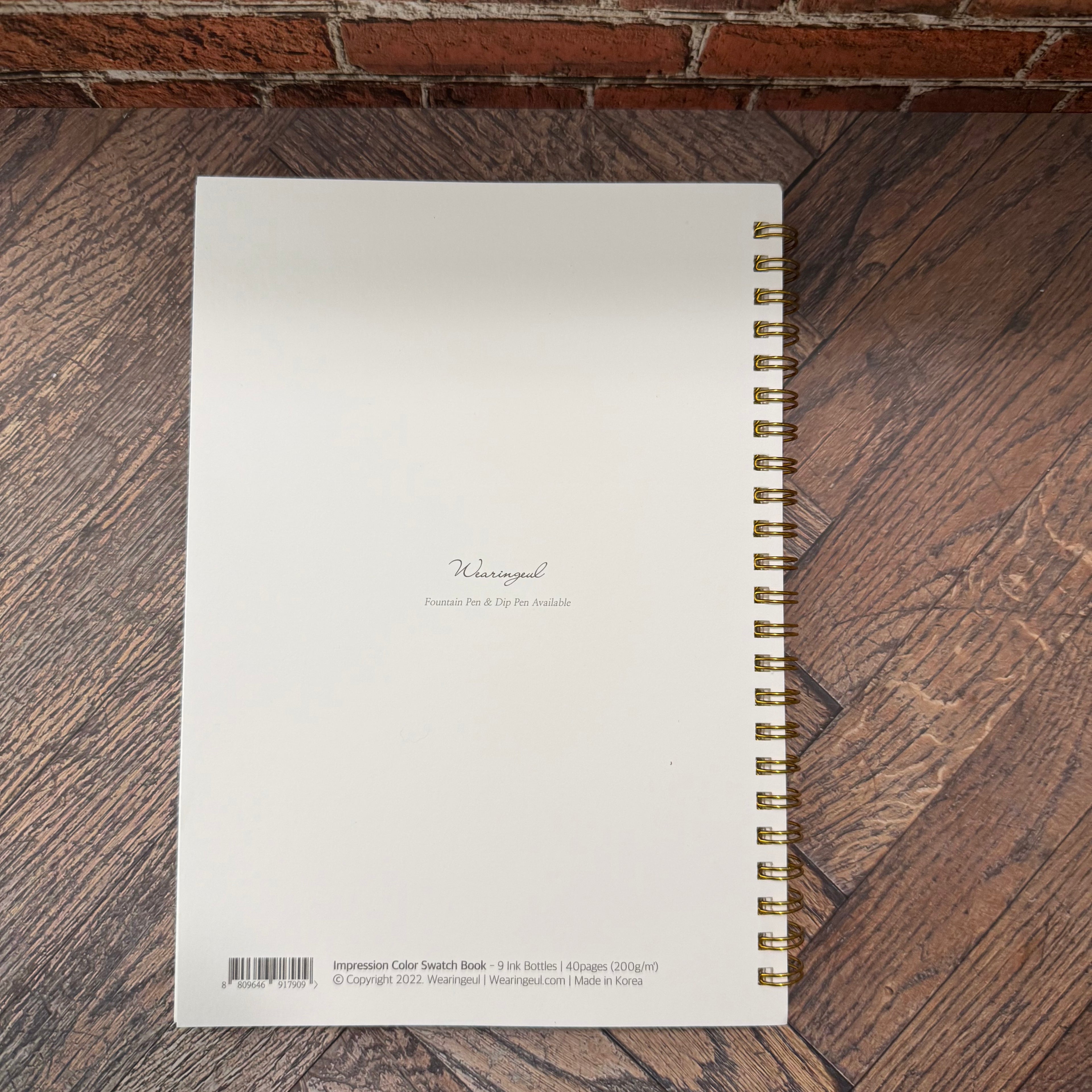 Back cover of Wearingeul Impression A5 ink color swatch book with product information and gold-tone wire binding