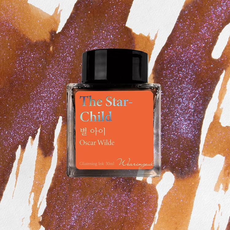 Wearingeul The Star Child fountain pen ink bottle over warm brown and blue-violet shimmering ink swatches