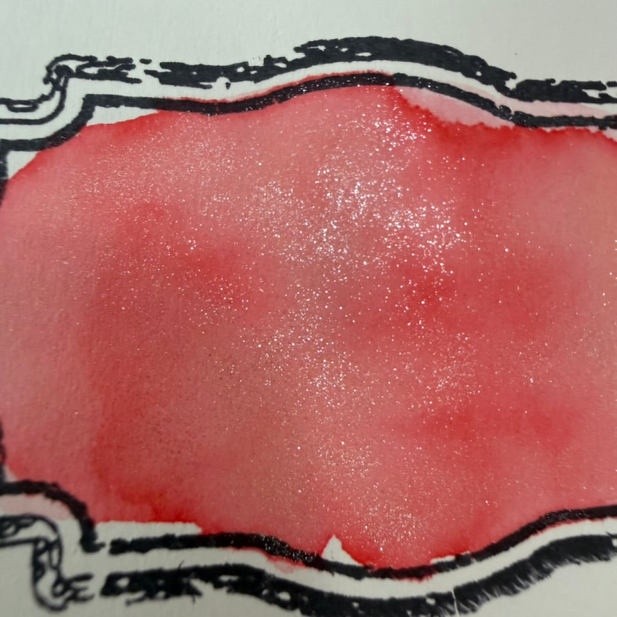 Wearingeul Thumbelina fountain pen ink swatch showing coral red pink shading and glistening shimmer on Tomoe River paper